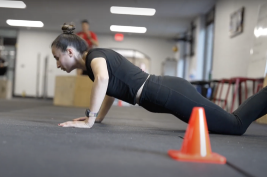 Woman doing pushups.