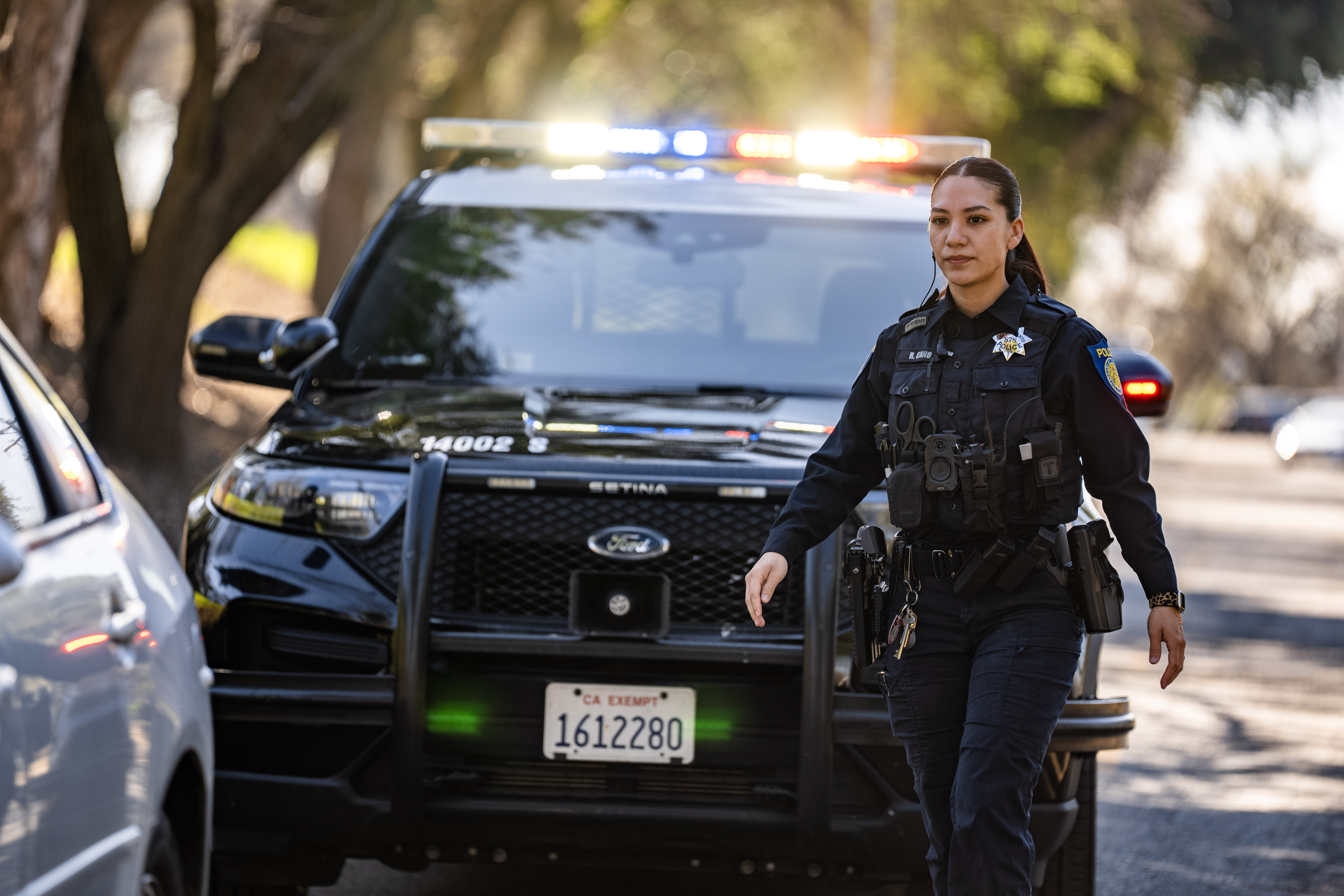 A Sacramento Police Department officer approaching a car door on a traffic stop